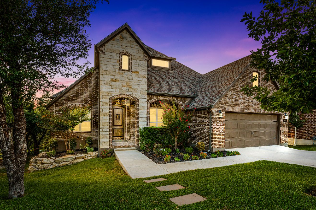 Brick and stone two-story home at twilight in San Antonio